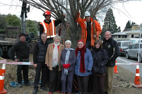 Elm Tree Ladies from left Donalda Anderson, Francis Lewis and Joan Cooke as workmen slot the special commemorative Elm into place. 